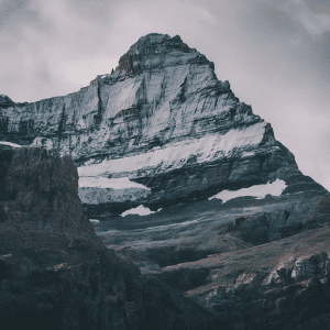 Imagen of A close-up photo of a mountain peak, showcasing the dramatic contrast between snow-capped summit and rugged rock face