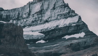 Imagen of A close-up photo of a mountain peak, showcasing the dramatic contrast between snow-capped summit and rugged rock face